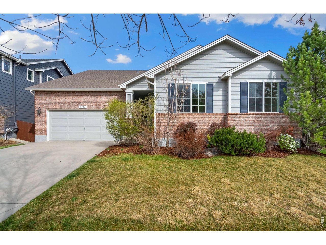 5574 Quarry Street Timnath, CO 80547 - Photo 2 of 43 a front view of a house with garden