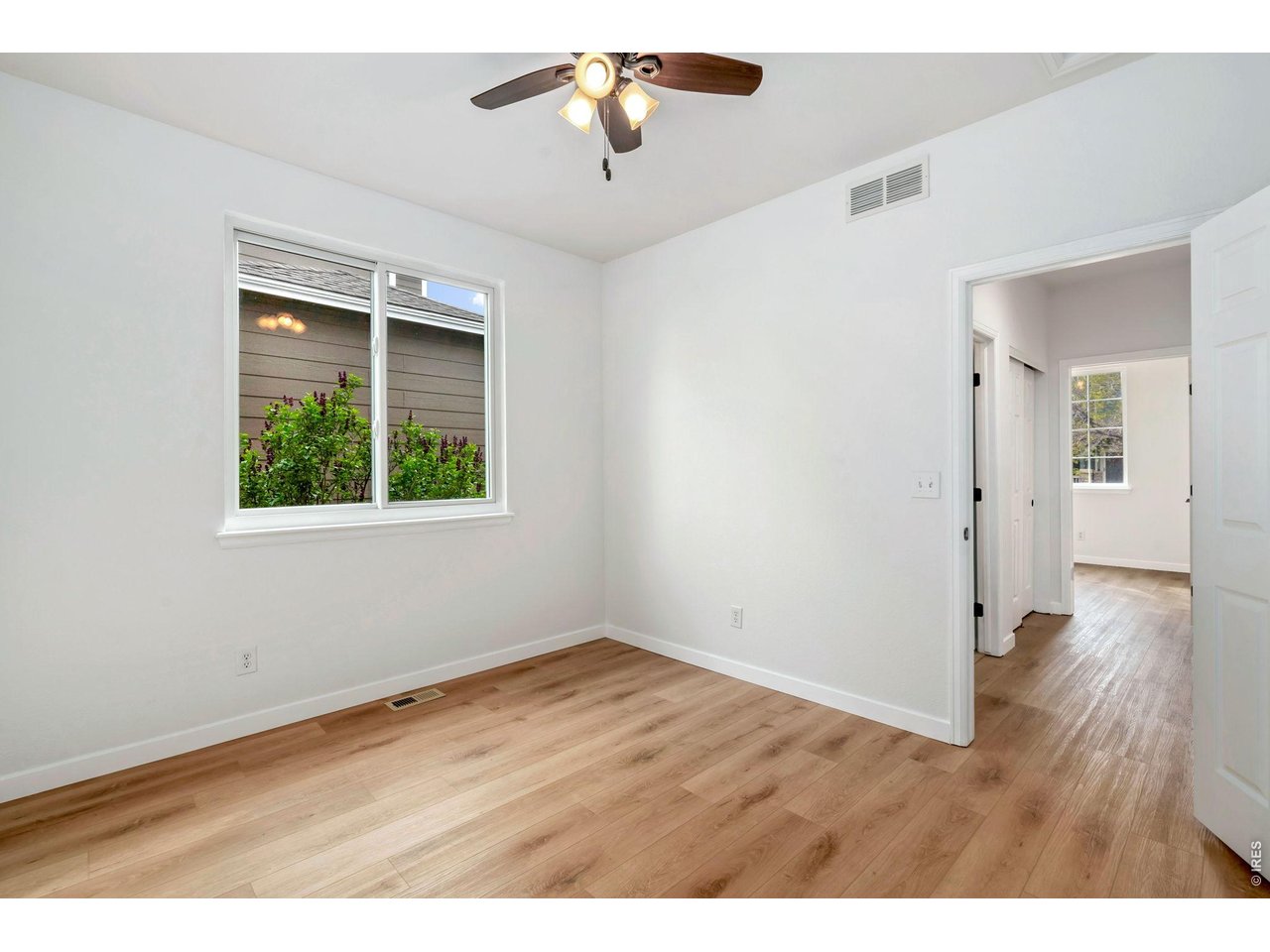 5574 Quarry Street Timnath, CO 80547 - Photo 25 of 43 a view of an empty room with wooden floor and a window