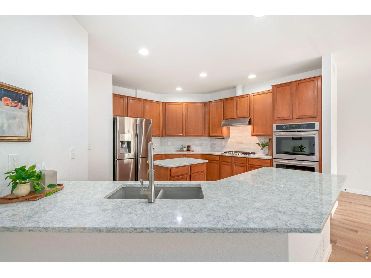 5574 Quarry Street Timnath, CO 80547 - Photo 9 of 43 a kitchen with stainless steel appliances granite countertop a sink refrigerator and stove