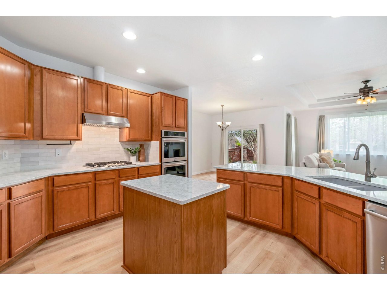 5574 Quarry Street Timnath, CO 80547 - Photo 10 of 43 a kitchen with stainless steel appliances granite countertop wooden cabinets a sink and dishwasher