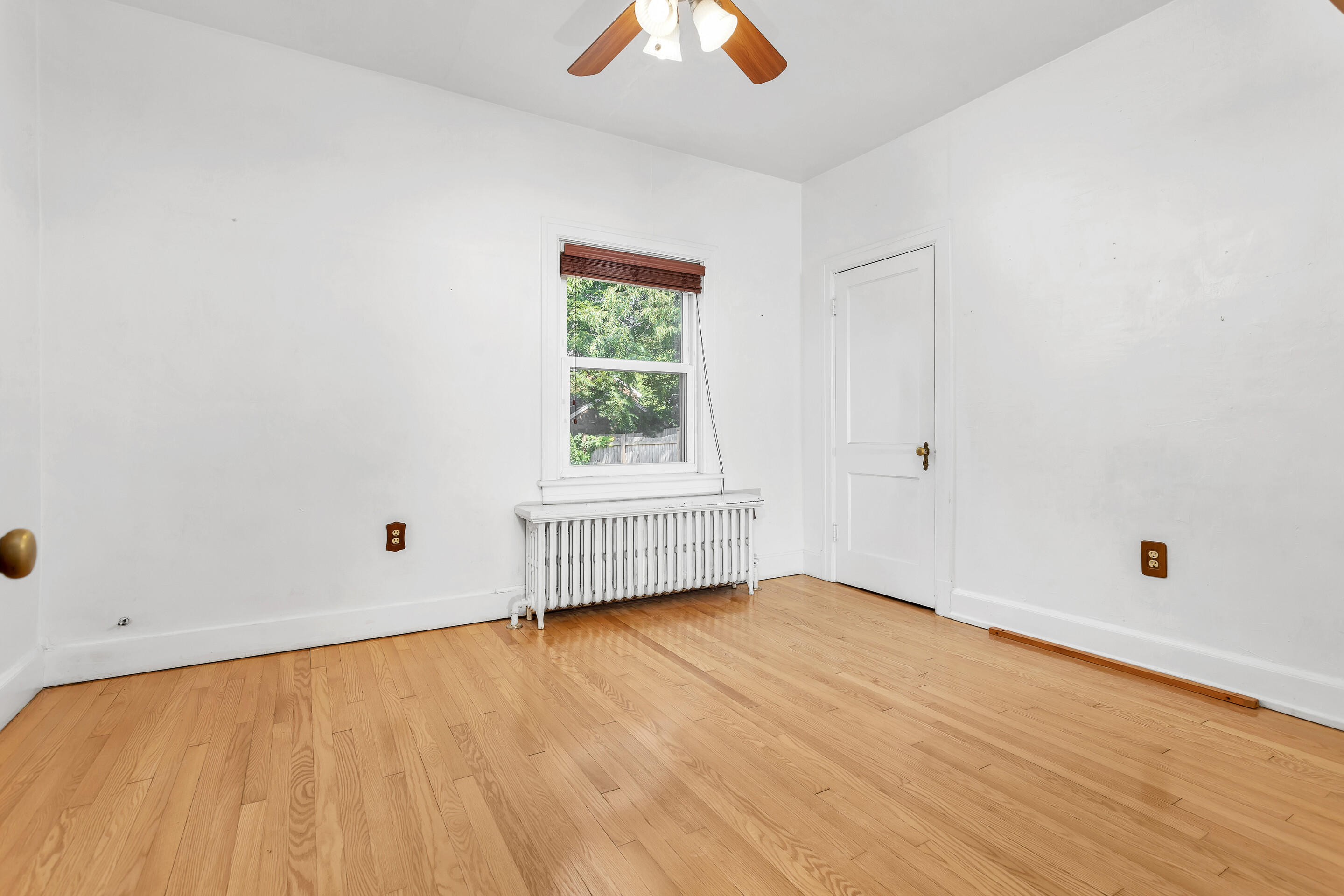 1809 Canterbury Road Southwest Roanoke, VA 24015 - Photo 11 of 29 a view of an empty room with wooden floor and a window