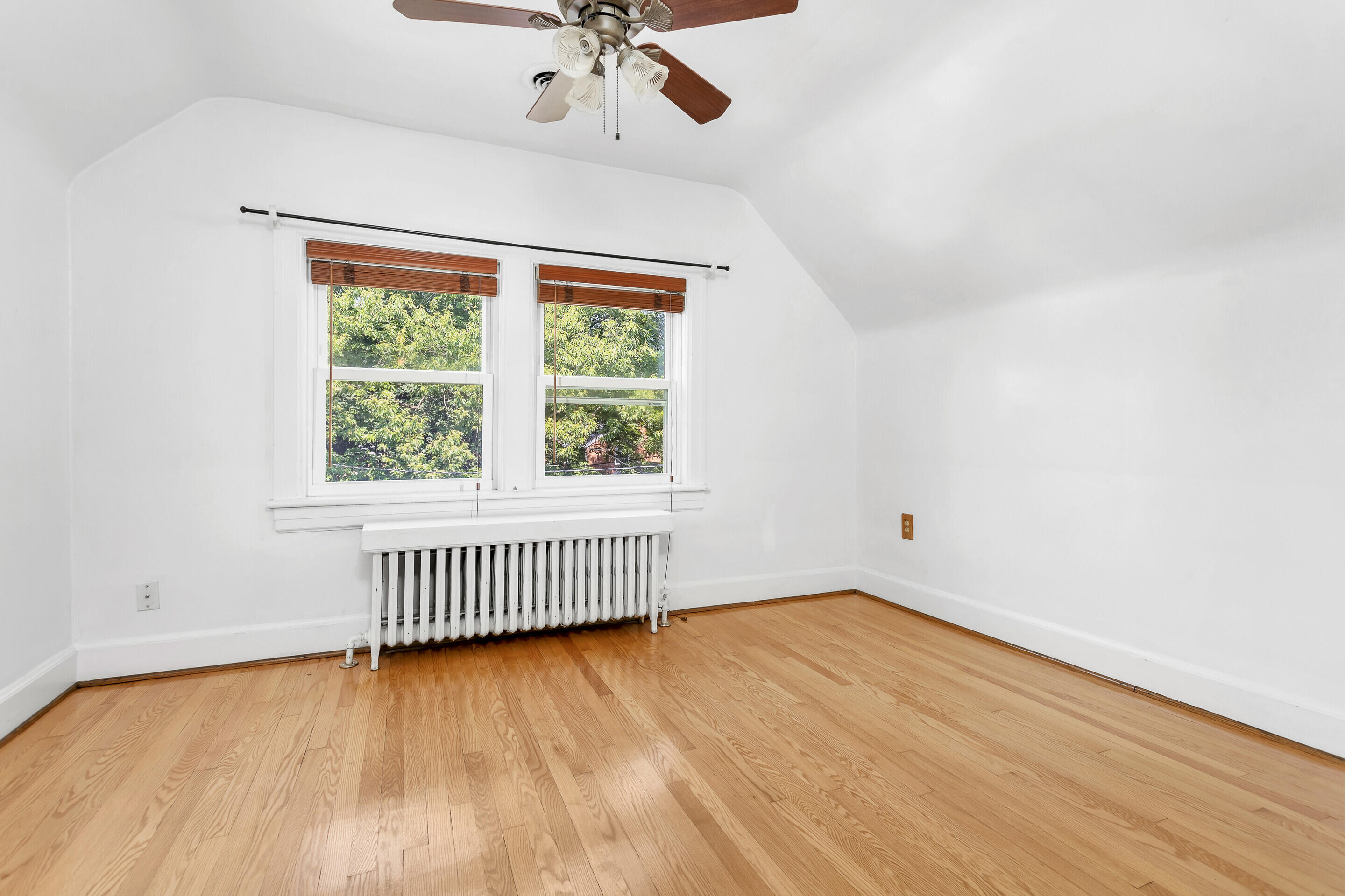 1809 Canterbury Road Southwest Roanoke, VA 24015 - Photo 14 of 29 an empty room with wooden floor fan and windows