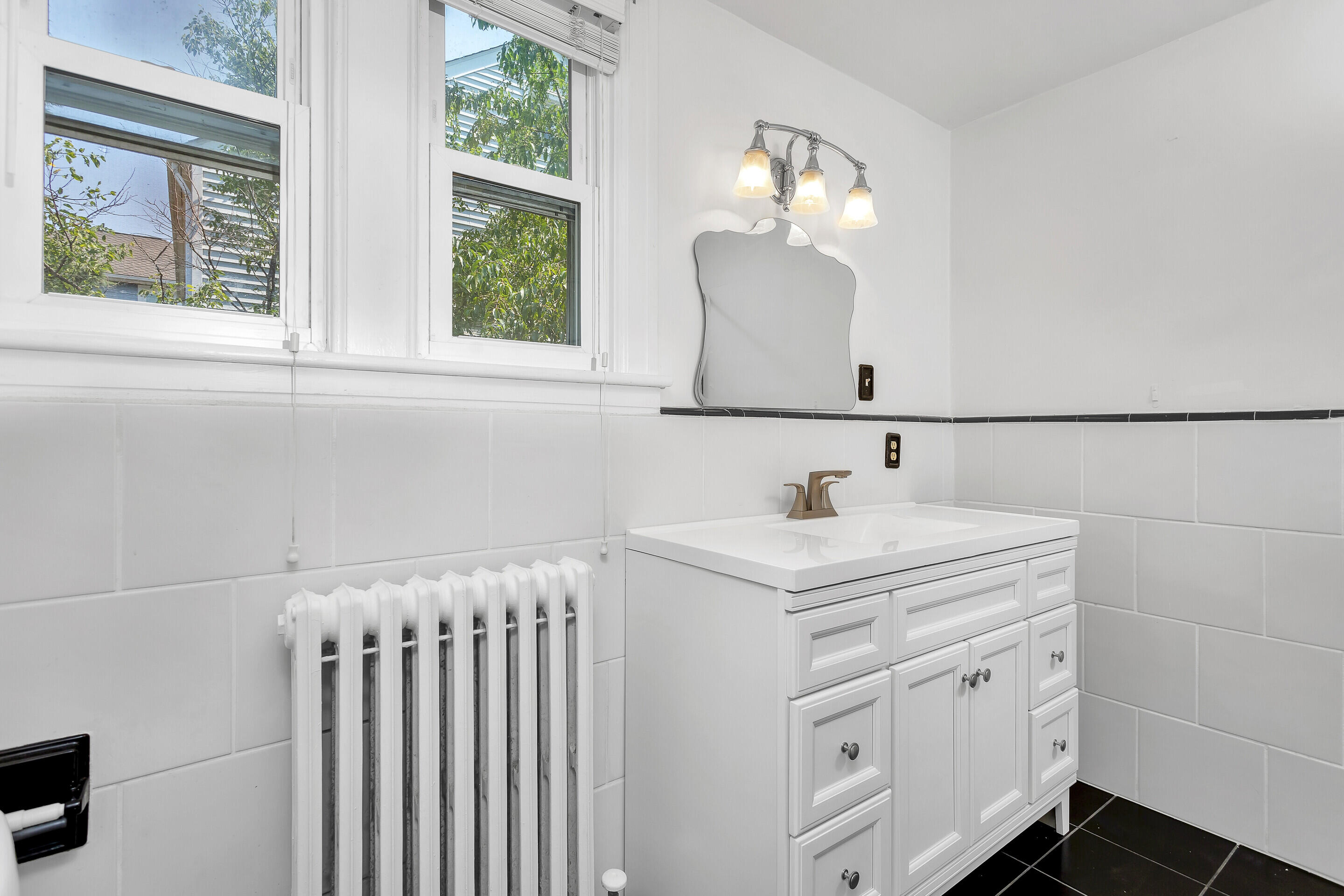 1809 Canterbury Road Southwest Roanoke, VA 24015 - Photo 16 of 29 a bathroom with a sink and a mirror