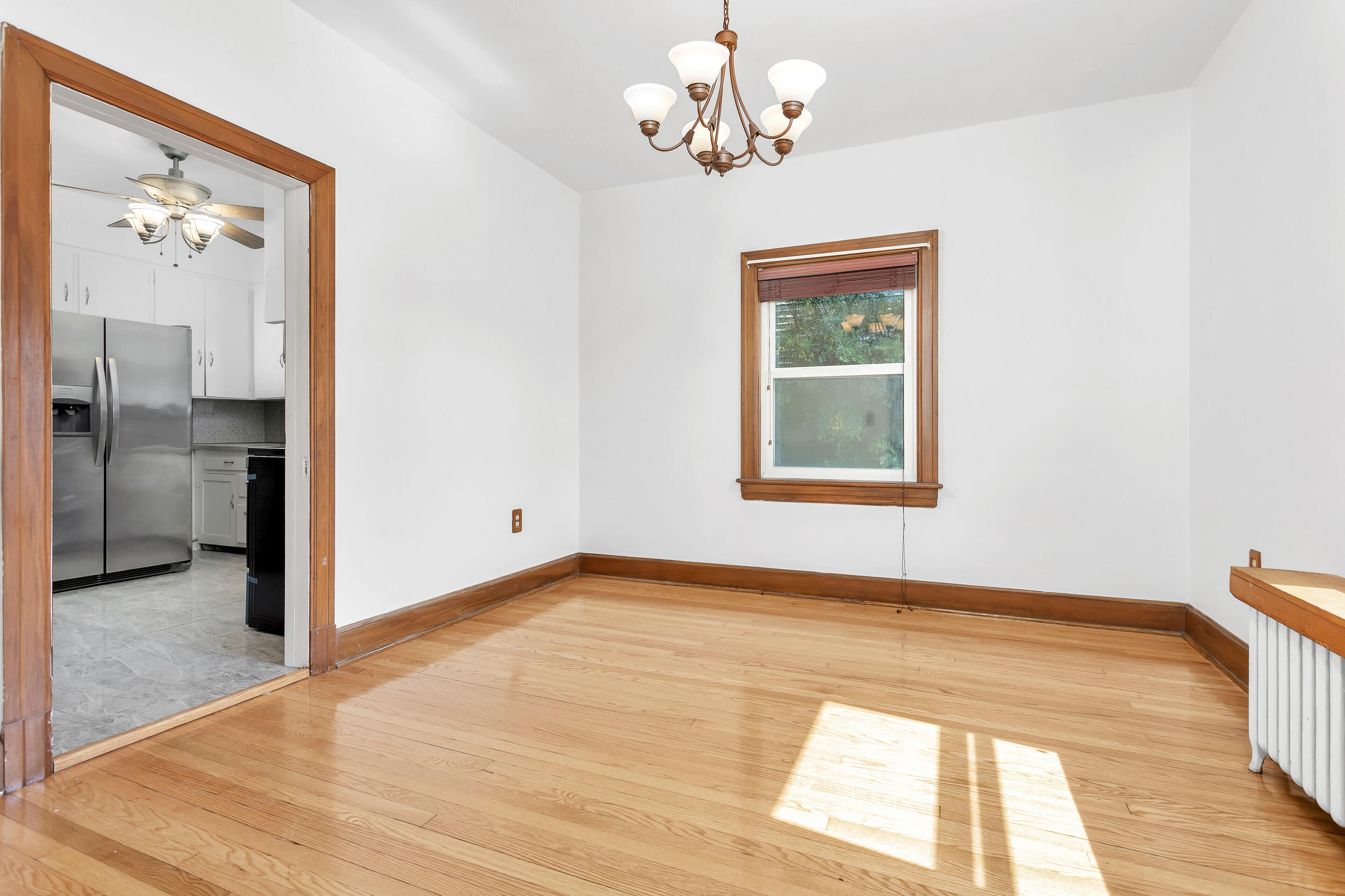 1809 Canterbury Road Southwest Roanoke, VA 24015 - Photo 6 of 29 a view of a hallway with wooden floor and a chandelier