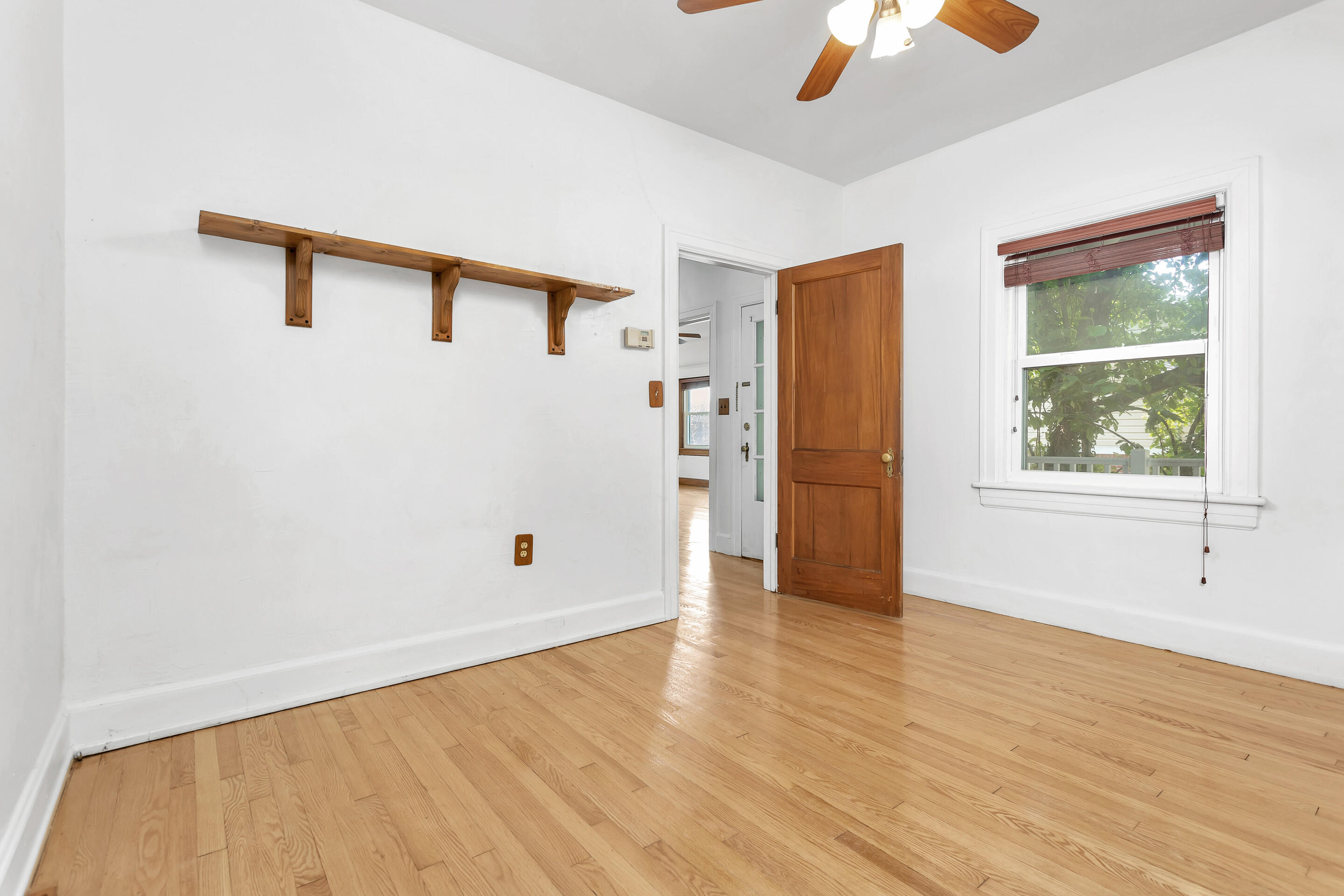 1809 Canterbury Road Southwest Roanoke, VA 24015 - Photo 10 of 29 a view of an empty room with a window and wooden floor