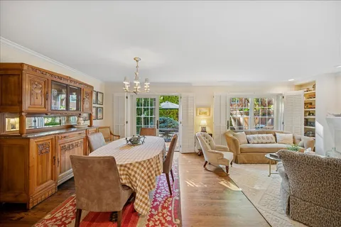 a living room with fireplace furniture and a large window