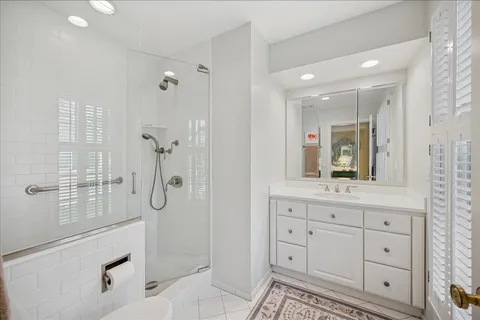 a bathroom with a shower sink and mirror