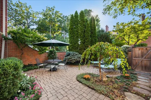 a view of a backyard with furniture and a garden