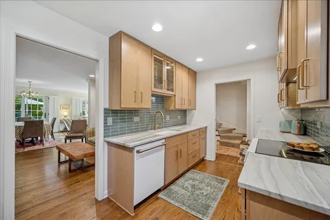 a kitchen with stainless steel appliances granite countertop a sink stove and cabinets