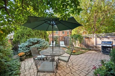 a view of backyard with outdoor seating and trees