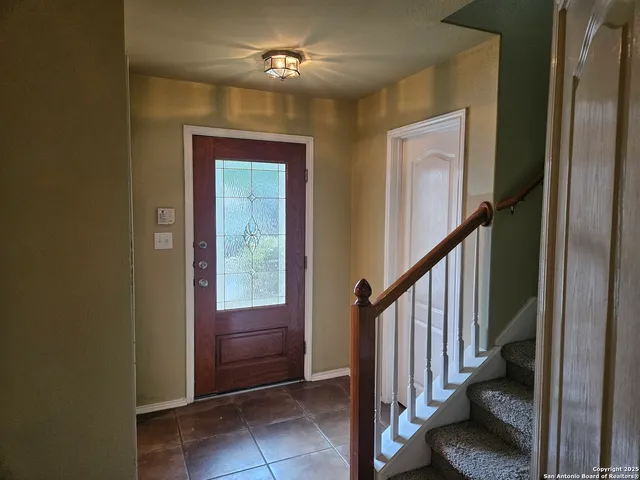 a view of entryway with stairs and a chandelier