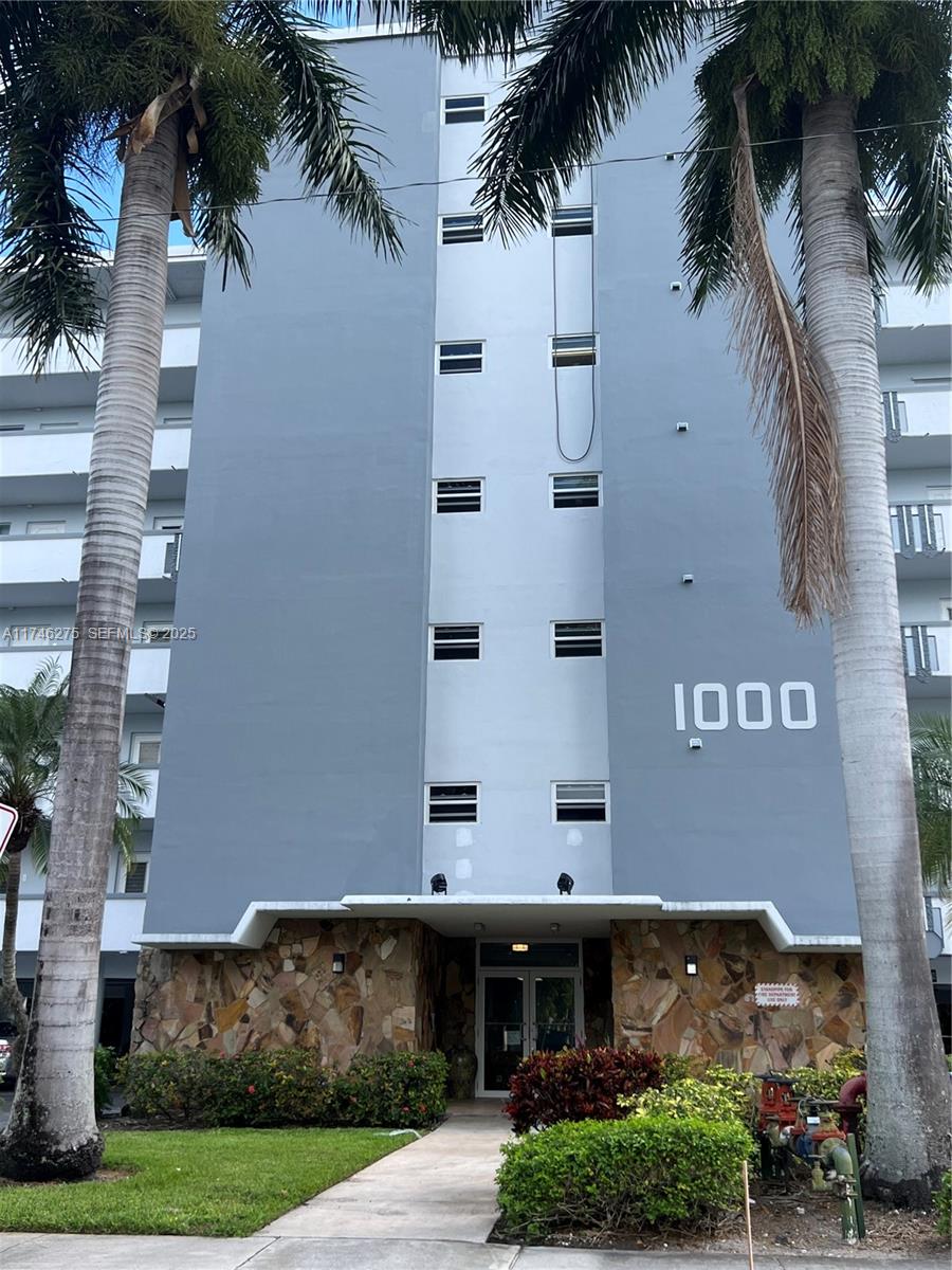 a front view of a building with plants