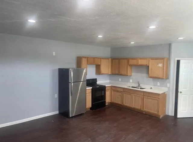 a kitchen with a sink stainless steel appliances and cabinets