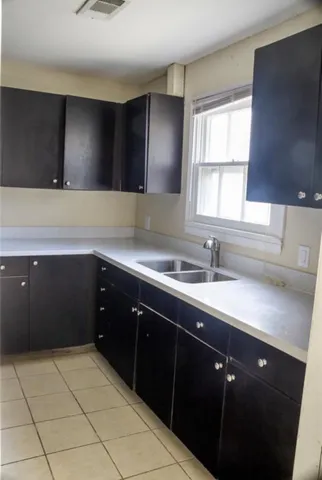 a kitchen with a sink and a wooden cabinets