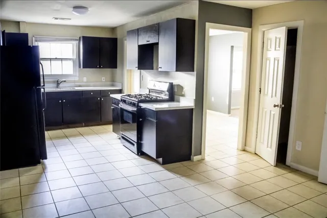 a kitchen with stainless steel appliances granite countertop a refrigerator and a stove top oven