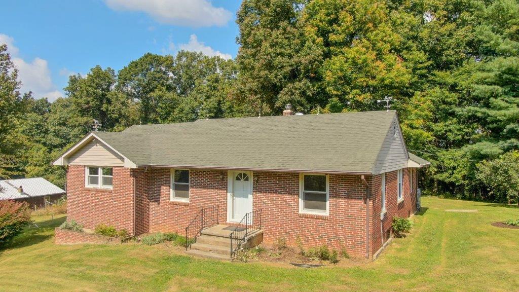 197 Silverleaf Road Southeast Floyd, VA 24091 - Photo 2 of 27 a front view of house with yard and trees in the background