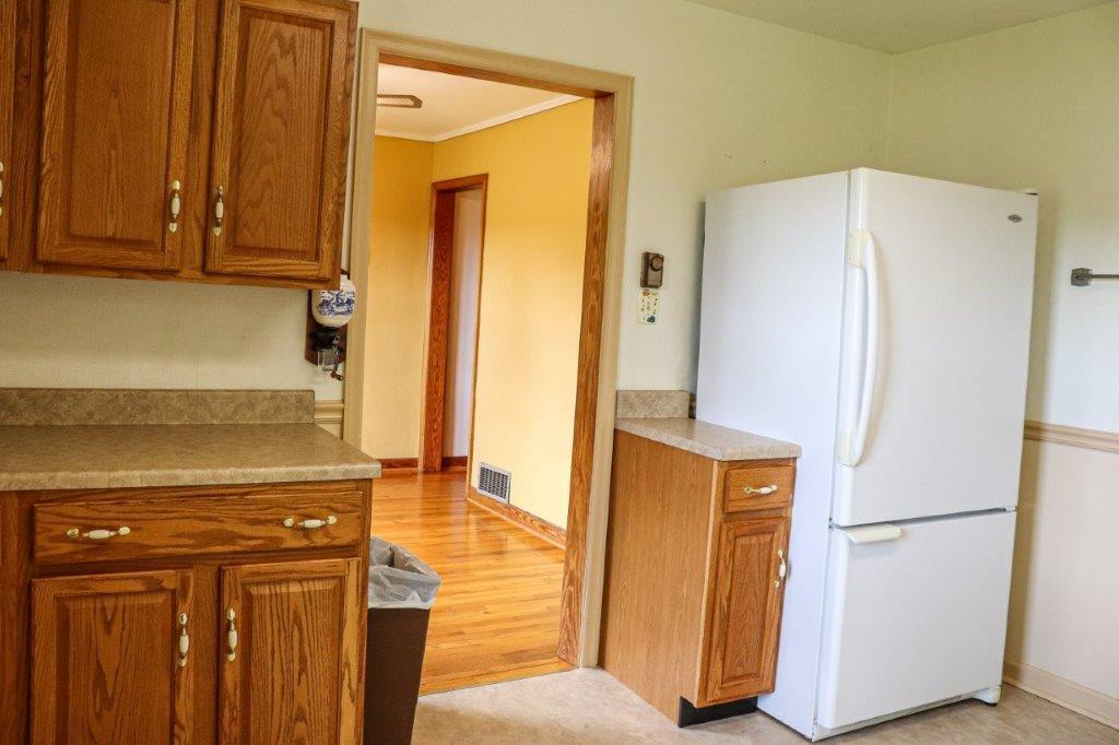 197 Silverleaf Road Southeast Floyd, VA 24091 - Photo 5 of 27 a kitchen with a refrigerator and cabinets