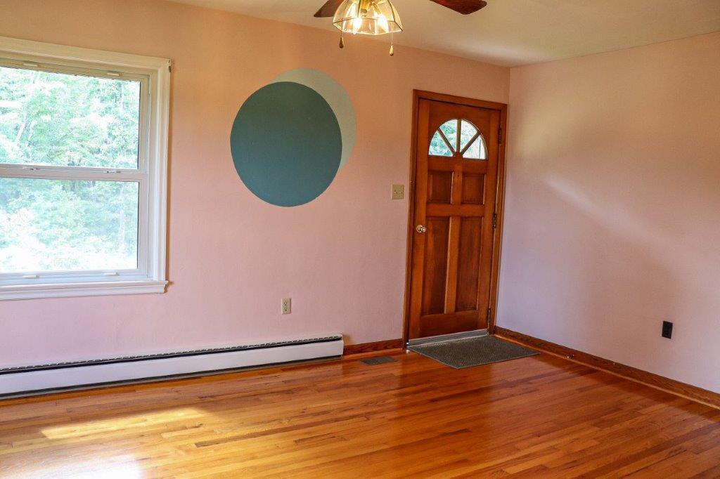 197 Silverleaf Road Southeast Floyd, VA 24091 - Photo 7 of 27 an empty room with wooden floor cabinet and windows