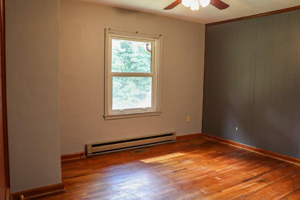 197 Silverleaf Road Southeast Floyd, VA 24091 - Photo 9 of 27 an empty room with wooden floor and windows