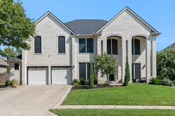 a front view of a house with a yard and garage