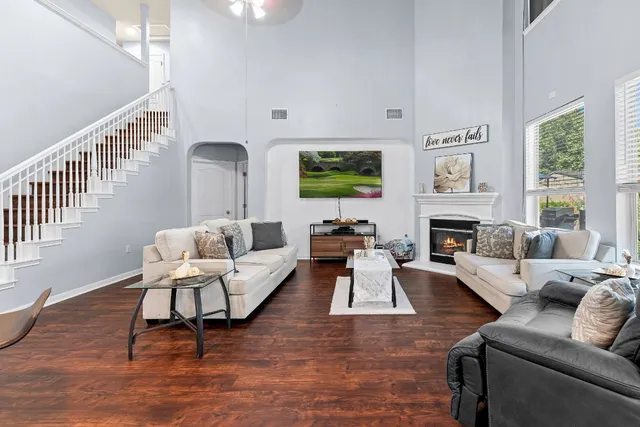 a living room with furniture fireplace and a window