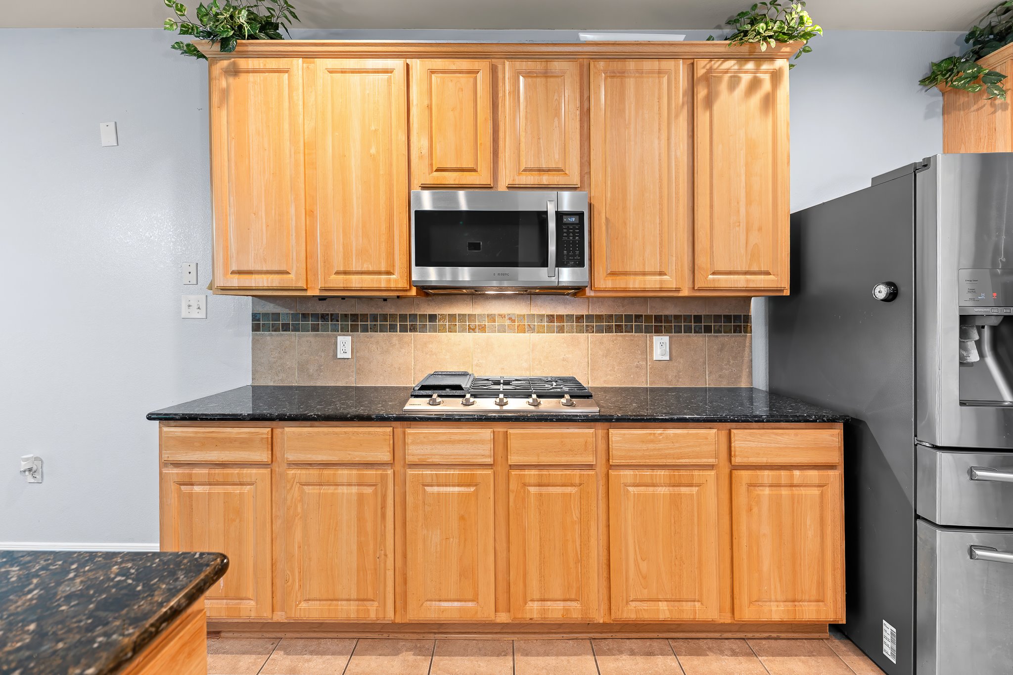 1211 Laurel Oak Trail Pflugerville, TX 78660 - Photo 16 of 40 a kitchen with stainless steel appliances granite countertop a refrigerator and a stove top oven
