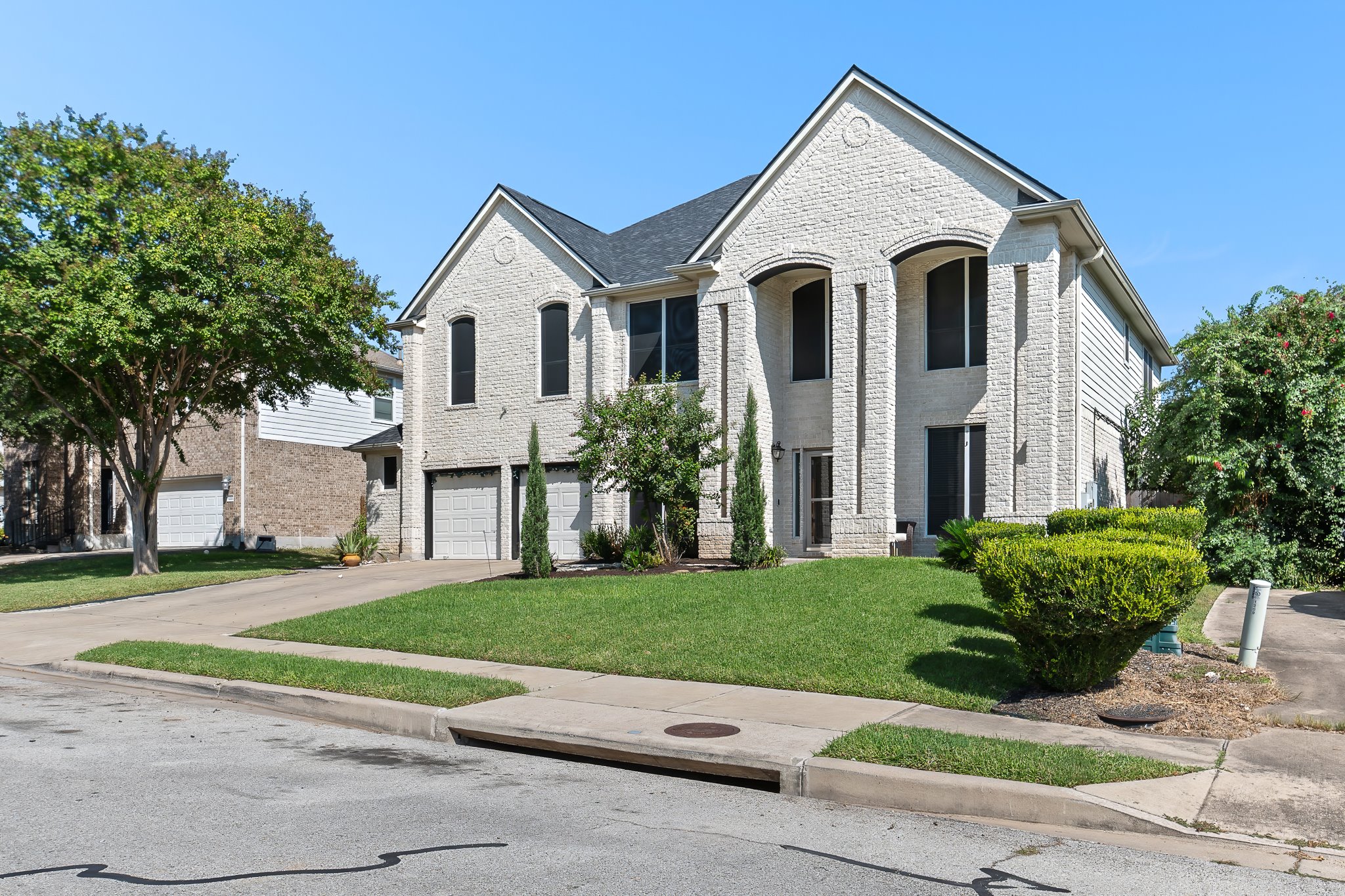 1211 Laurel Oak Trail Pflugerville, TX 78660 - Photo 2 of 40 a view of a white house with a yard and large trees