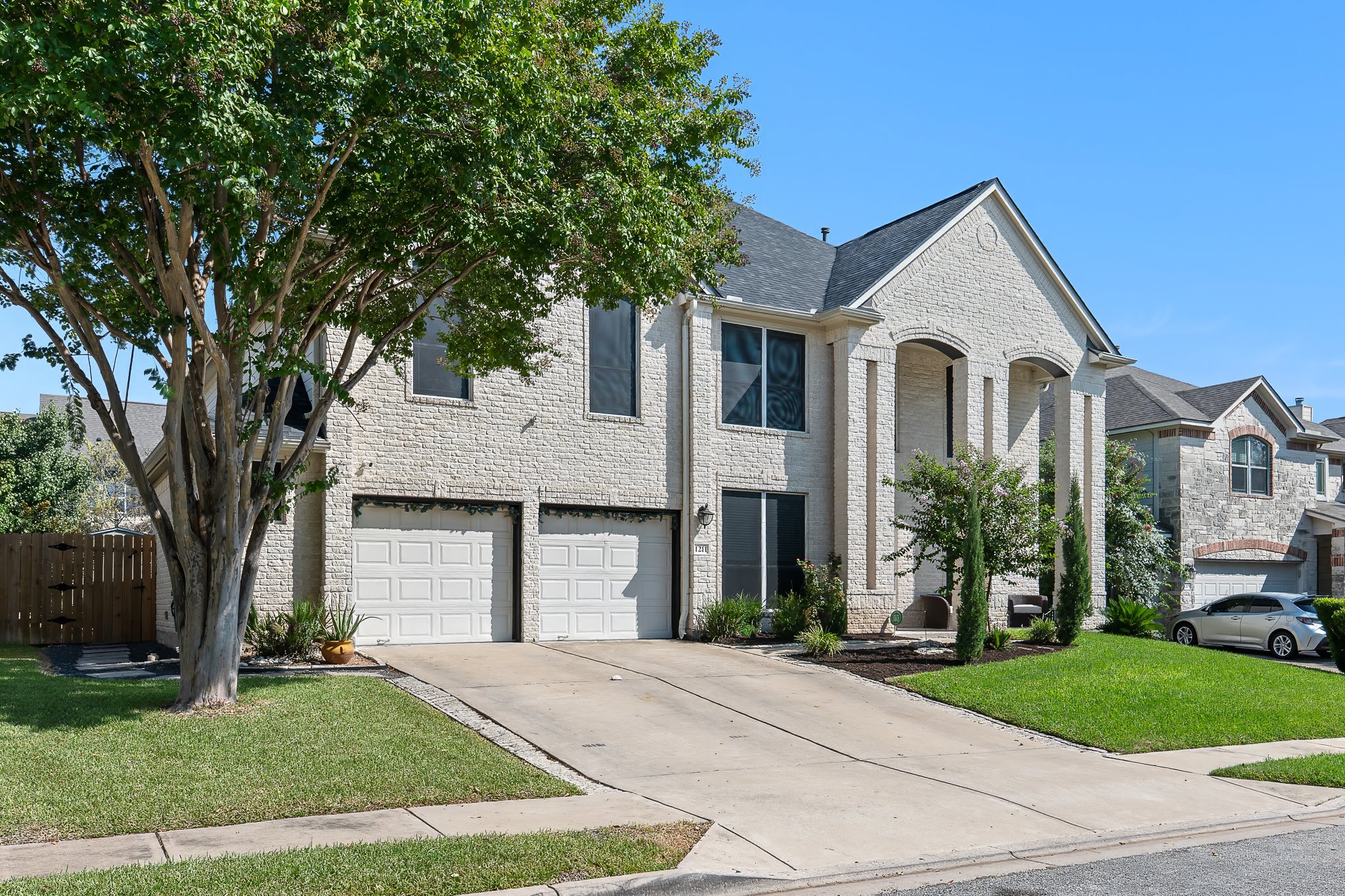 1211 Laurel Oak Trail Pflugerville, TX 78660 - Photo 3 of 40 a front view of a house with a garden and trees