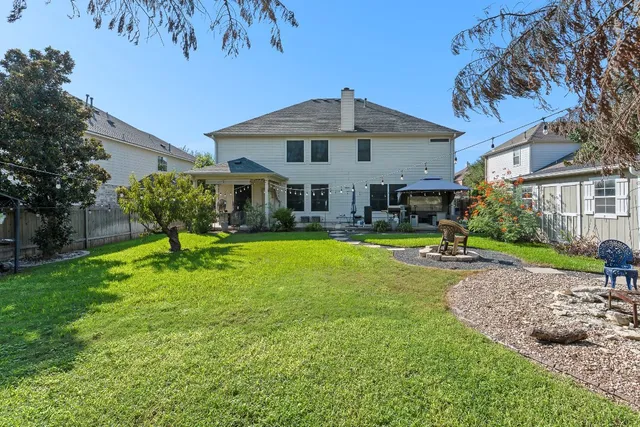 a view of a house with swimming pool and sitting area