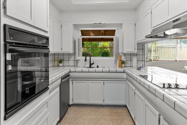 a kitchen with a sink and cabinets