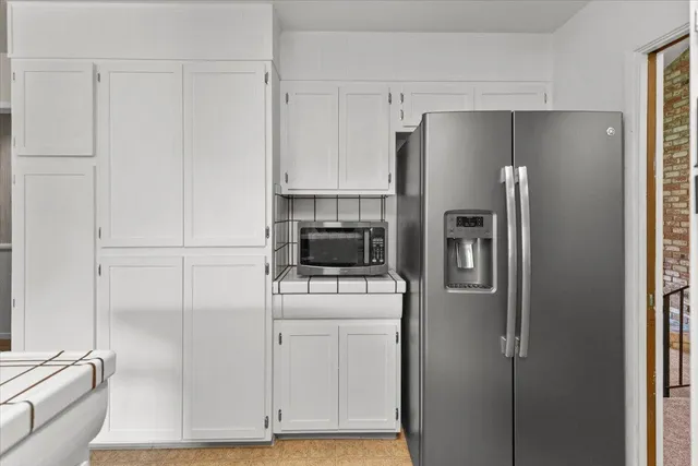 a living room with furniture a dining table and a chandelier