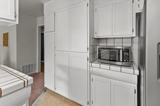 a view of a dining room with furniture a chandelier and wooden floor