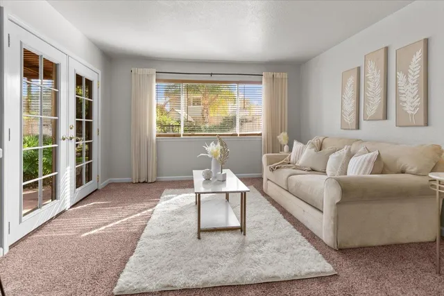 a view of a hallway with a window and wooden floor