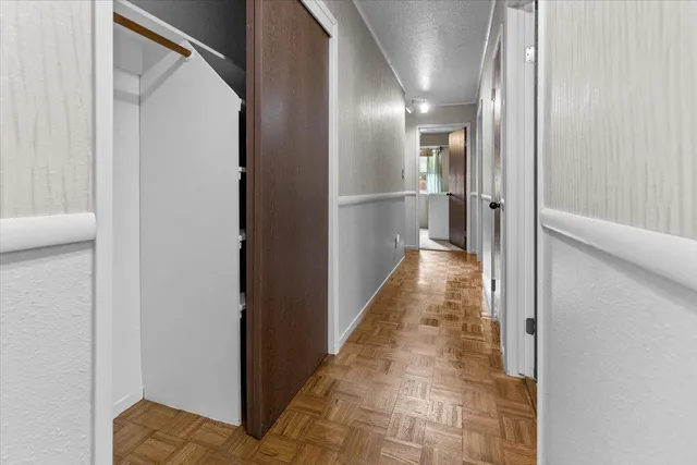 a bedroom with a bed potted plant and a chandelier