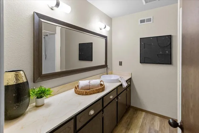 a bedroom with a bed and a potted plant