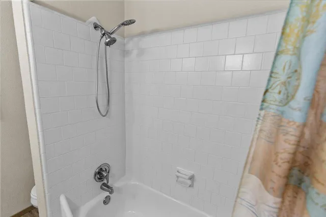 a utility room with stainless steel appliances granite countertop a sink and a refrigerator