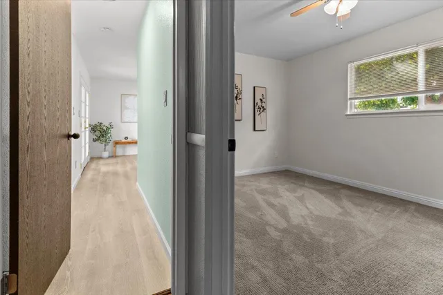 a view of patio with table and chairs potted plants with wooden floor