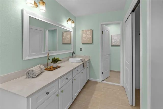 a view of a house with a big yard plants and large trees