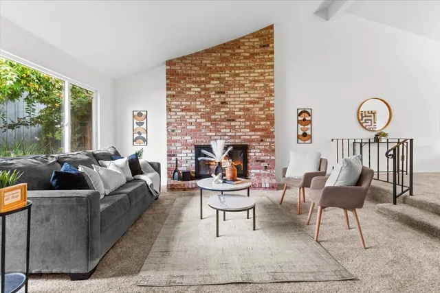 a dining room with furniture a rug and a chandelier