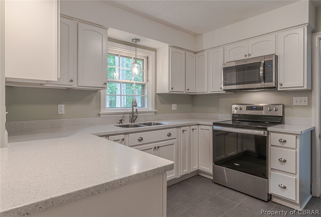 89 Walnut Road Kilmarnock, VA 22482 - Photo 14 of 38 Solid Surface, Soft Close Cabinetry, Ceramic Tile Floors