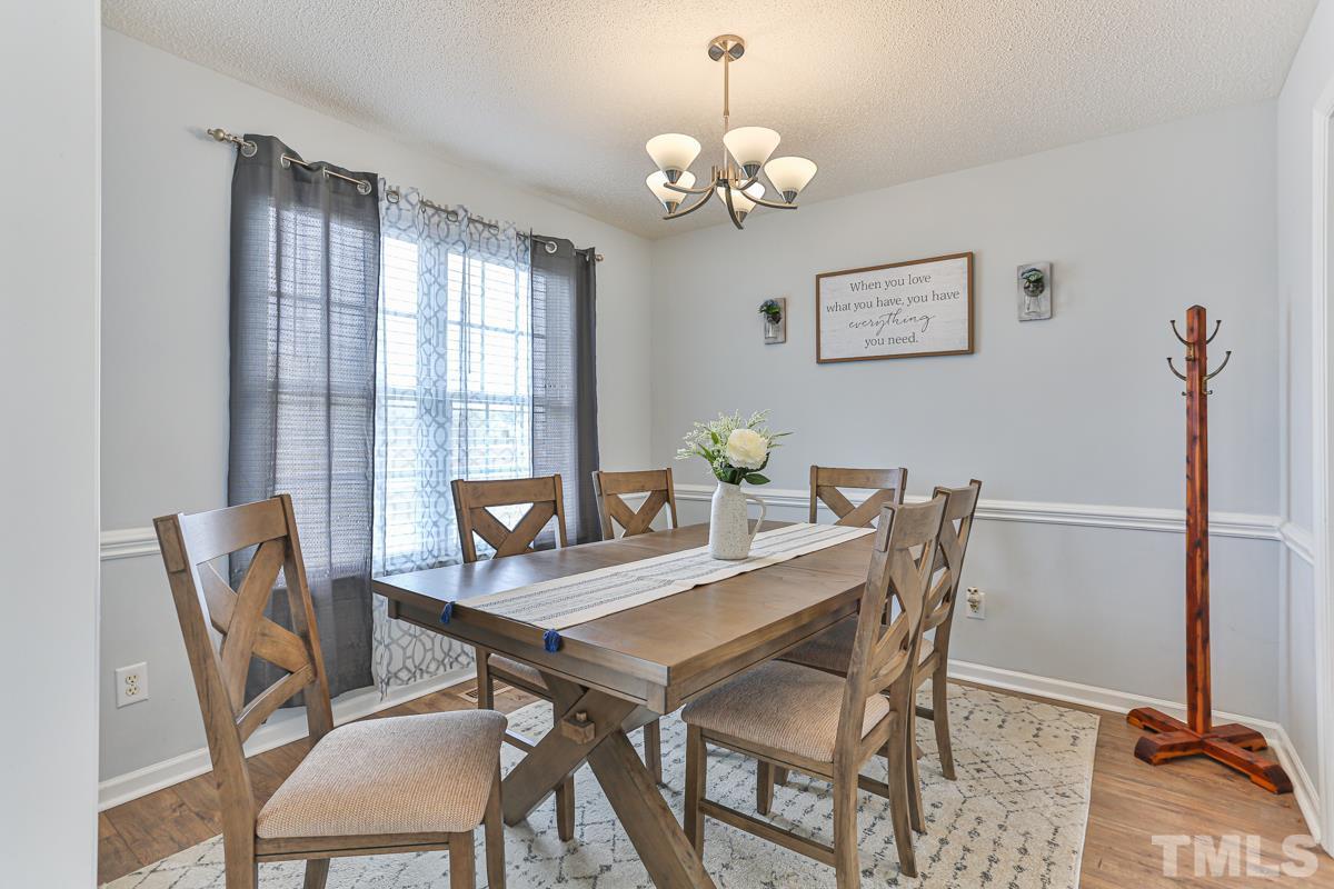 243 Rosa Circle Willow Spring, NC 27592 - Photo 3 of 28 a view of a dining room with furniture and chandelier