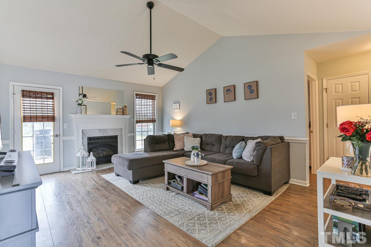 243 Rosa Circle Willow Spring, NC 27592 - Photo 5 of 28 a living room with furniture a fireplace and a window