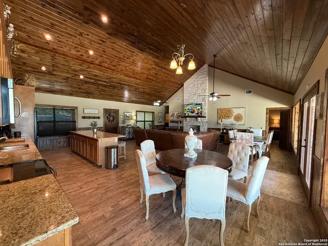 a outdoor space with lots of tables a large window and chairs