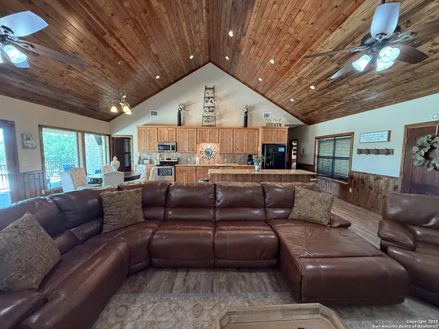 a living room with furniture ceiling fan and a rug