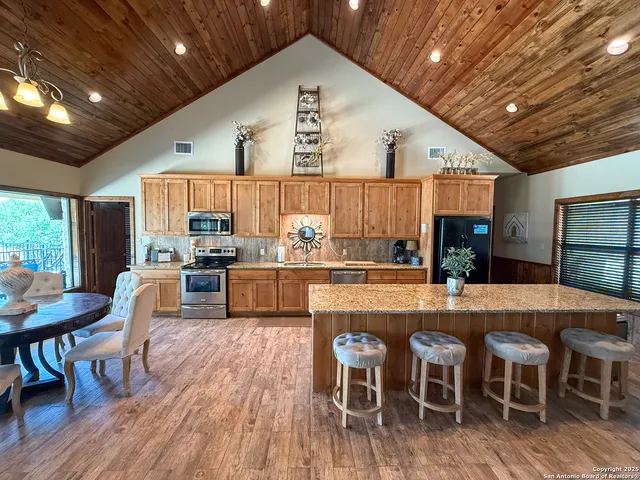 a large kitchen with a table and chairs