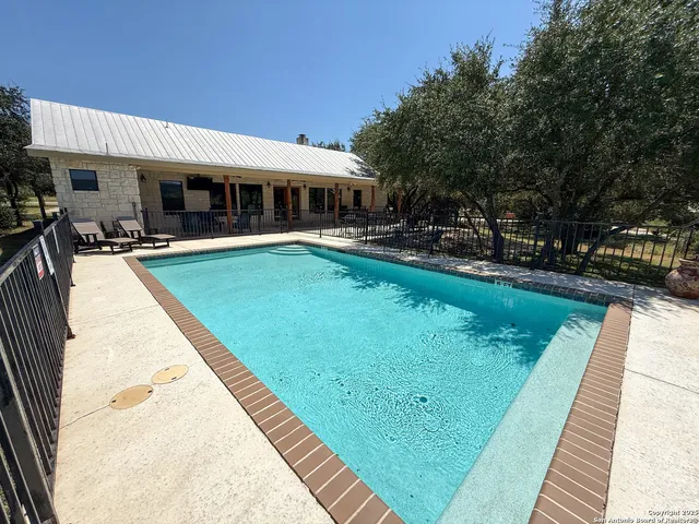 a view of a house with swimming pool patio and outdoor seating