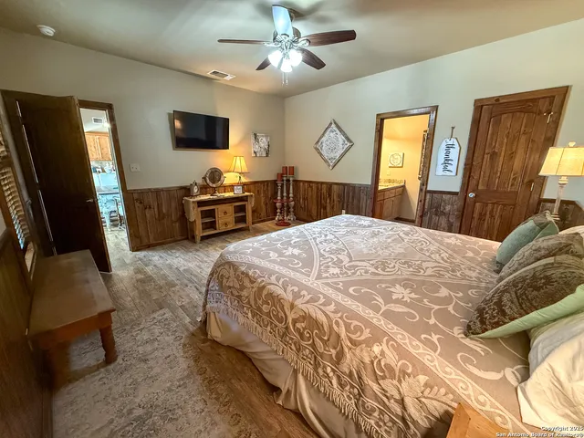 a bedroom with a bed a window and dresser