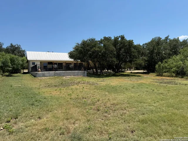a view of swimming pool with outdoor seating and covered with trees