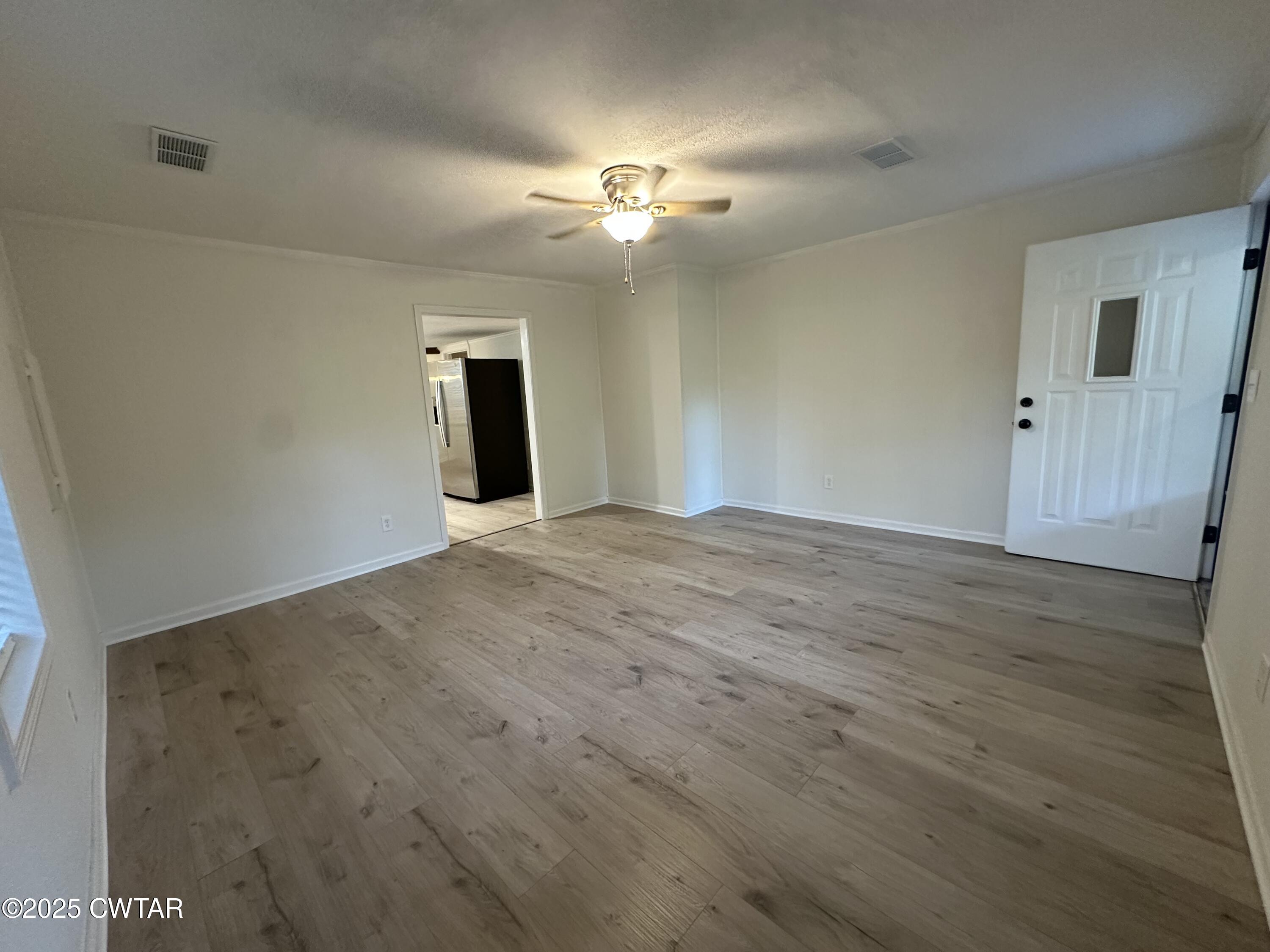 1975 Old Toone Road Medon, TN 38356 - Photo 4 of 21 a view of a livingroom with a ceiling fan and wooden floor