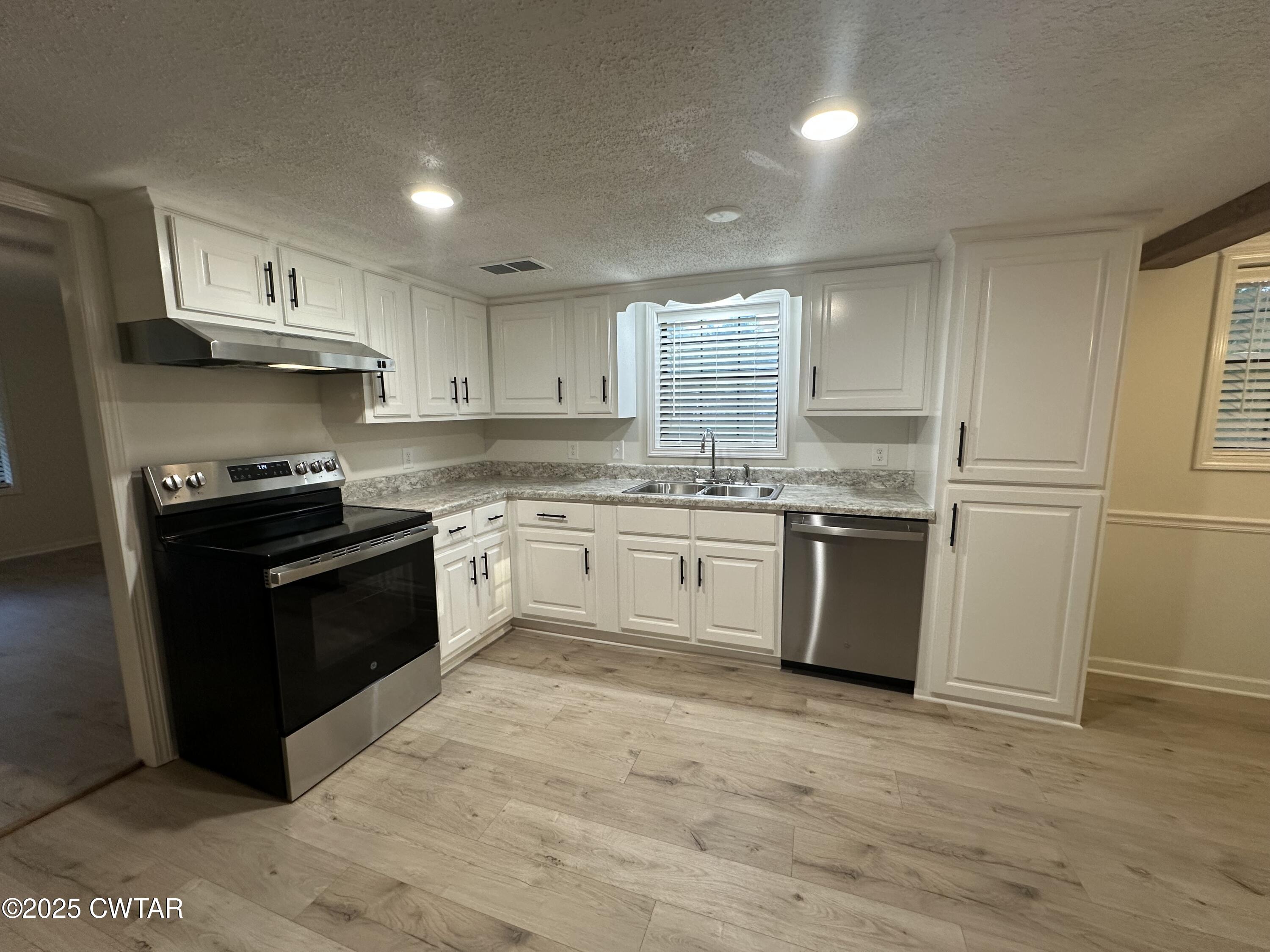 1975 Old Toone Road Medon, TN 38356 - Photo 7 of 21 a white kitchen with granite countertop stainless steel appliances